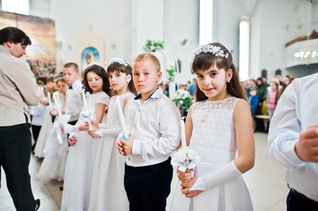 LVIV, UKRAINE - MAY 8, 2016: The ceremony of a First Communion in the Church of St. Peter the Great of Ukrainian Greek Catholic Church.のeditorial素材