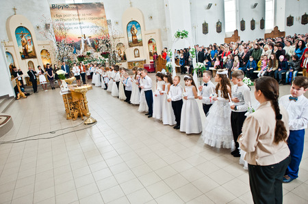 LVIV, UKRAINE - MAY 8, 2016: The ceremony of a First Communion in the Church of St. Peter the Great...