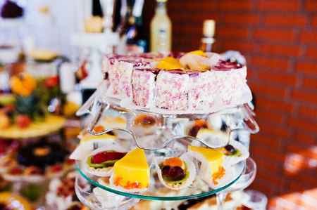 Elegance wedding reception table with food and cakesの写真素材
