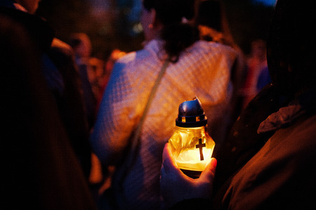 Funeral candle lamp in hand at night