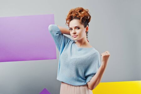 Studio portrait of young girl near art colored blanks.