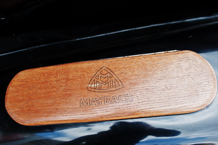 Podol, Ukraine - May 19, 2016: Logo on wood element of luxury retro car Maybach.