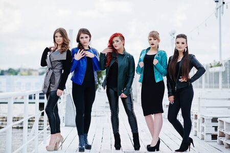 Five beautiful young girls models at leather jackets posing on berth.の写真素材