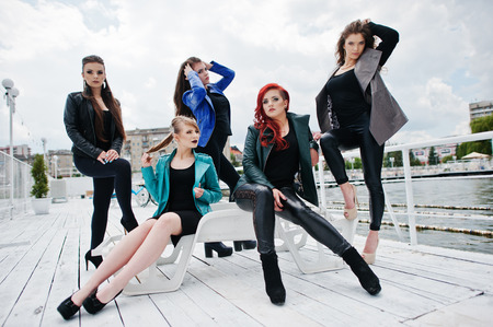 Five beautiful young girls models at leather jackets posing on berth.の写真素材