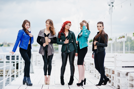 Group of sexy models girls in black bra and leather jackets on the dockの写真素材