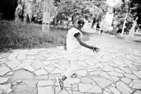 Amazing beautiful african american baby girl with sunglasses having funの写真素材