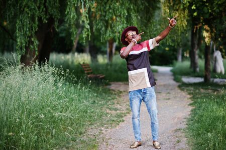 Fashionable and stylish black man with sunglasses and hat