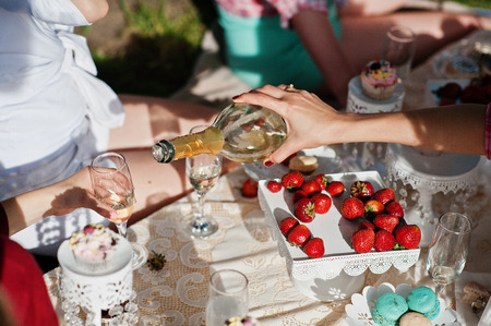 Close up champagne glasses on hands of friends at bachelorette partyの写真素材