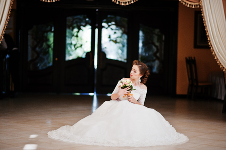 Portrait of beautiful bride at wedding hall background curtainsの写真素材