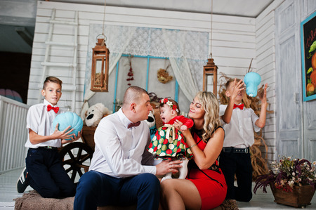 Caucasian family posed in vintage studio roomの写真素材