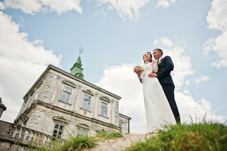 Wedding couple background old vintage castle. Happy newlyweds at their wedding day.の写真素材