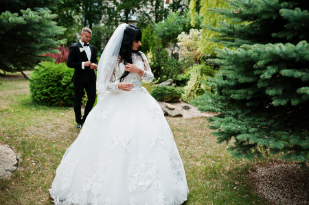 Glamourus wedding couple on garden of pine trees.の写真素材