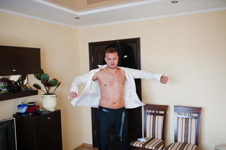 Man wearing shirt. Groom morning at wedding day.の写真素材