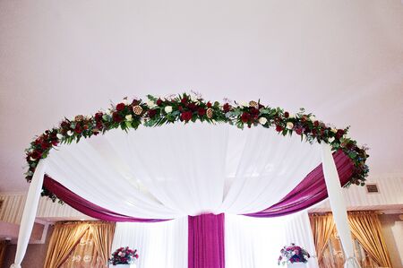 Wedding arch with flowers of table newlyweds.の写真素材