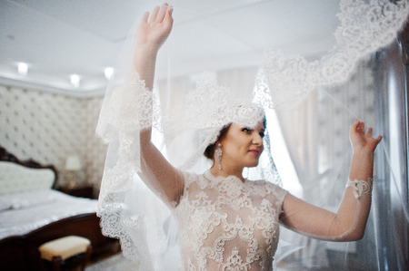 Young brunette bride posed on her room at wedding day.の写真素材