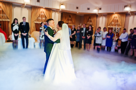 First wedding dance of newlyweds on heavy smoke.の写真素材