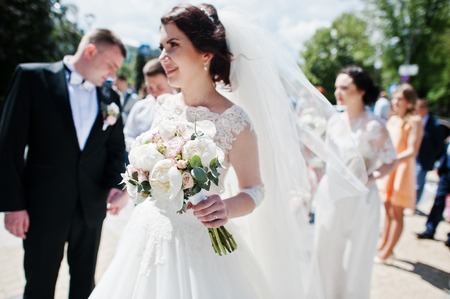 Soft focus on wedding bouquet at hand of bride.の写真素材