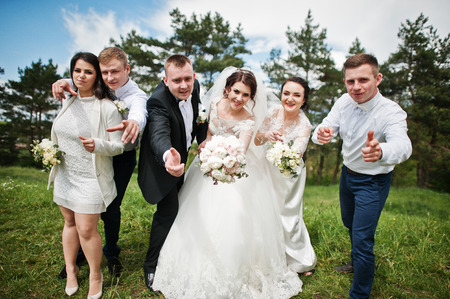 Funny and happy wedding couple with bridesmaids and best mans.の写真素材