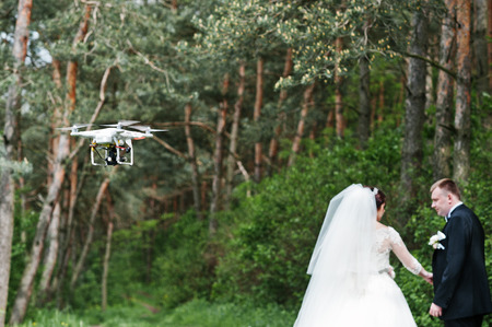 Drone quadcopter recording on air wedding couple at forest.の写真素材