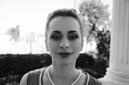 Close up portrait of young pinup girl wearing at retro vintage old-fashioned dress in peas, retro styling.の写真素材