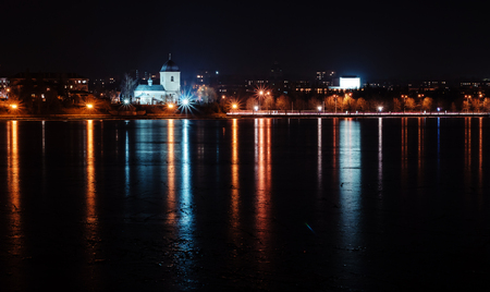 Panorama of night city lights and reflections on lake at Ternopil, Ukraine, Europe.の写真素材