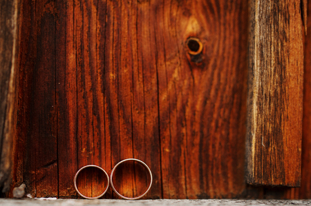 Wedding rings on wooden background. Love concept of marriage.の写真素材