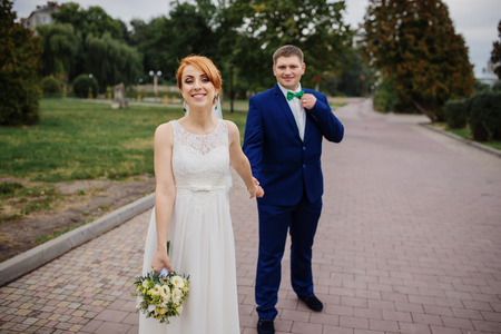 Wedding couple in love at cloudy day, walking on city.の写真素材