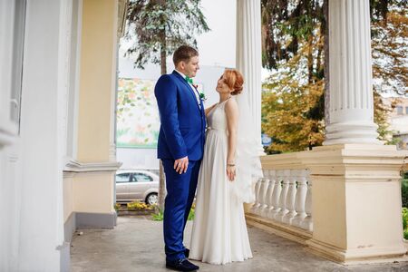 Wedding couple in love background large columns of antique house.の写真素材