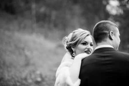 Wedding couple in love at autumn pine wood. Black and white photoの写真素材