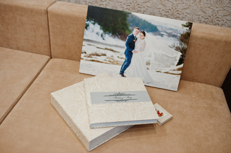 Elegant wedding album and photo book from beige material with large picture of wedding couple on canvas.の写真素材