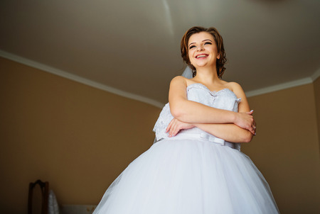 Young bride posed at her room in morning wedding.の写真素材