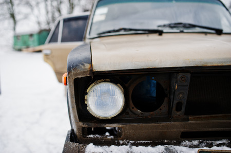 Headlights of old soviet car on snowy weather.の写真素材