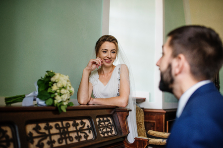 Groom play on piano for his smiling bride at their wedding day.の写真素材