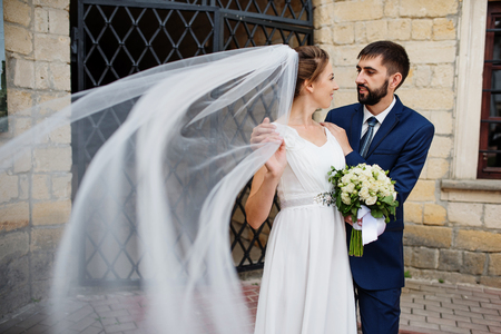 Wedding couple near old wrought iron gates.の写真素材