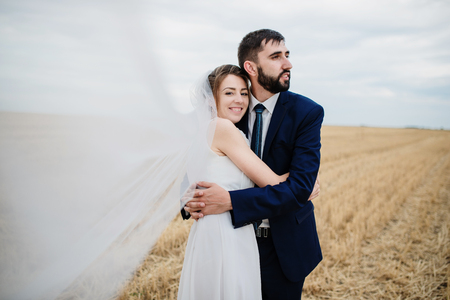 Wedding couple in love at wheat field with stubble.の写真素材