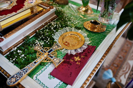 Wedding rings at discus with cross at church.の写真素材