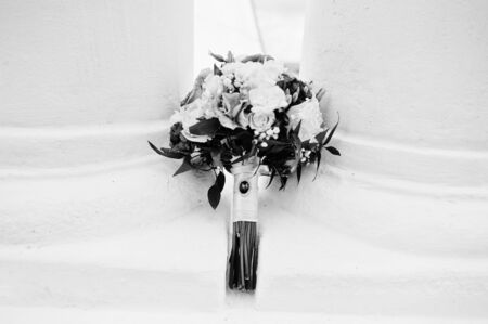 Beautiful violet and white wedding bouquet under two columns.の写真素材