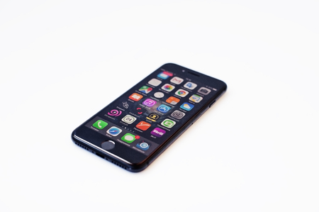 Hai, Ukraine - February 28, 2017:  Apple Iphone 7 display on with programs at IOS isolated on white background.のeditorial素材