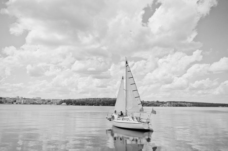 Wedding couple in love at small sailboat yacht on lake.の写真素材