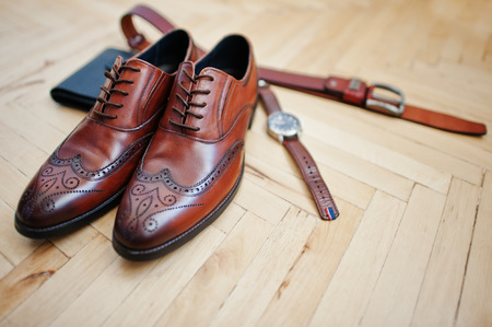 Accessories for mens lay on the wooden parquet floor.の写真素材