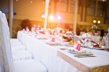 Table of newlyweds with dises and chairs.の写真素材