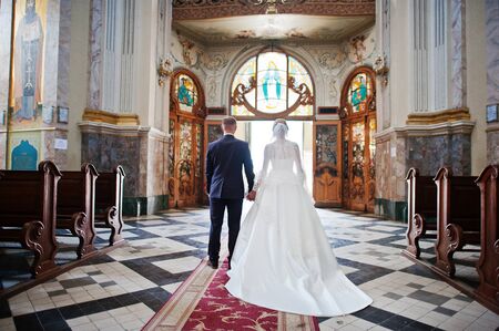 Wedding couple walking happy in love at church.の写真素材