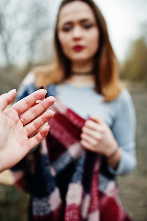 Hand of girl with cigarette. Stop smoking social problem. Friend give smoke to friend.の写真素材