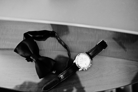 Men's accessories for groom at wedding: watches and bow tie.の写真素材