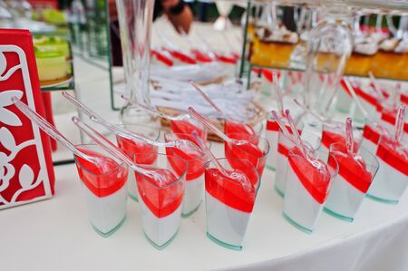 Wedding catering table with different sweets and cakes.の写真素材