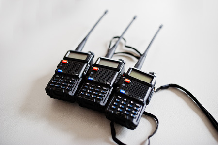 Three portable radio transmitter at steel background.の写真素材