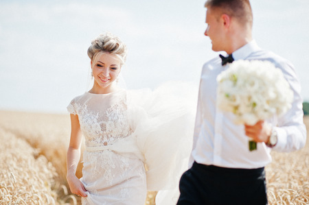 Wedding couple at field of wheat in love.の写真素材