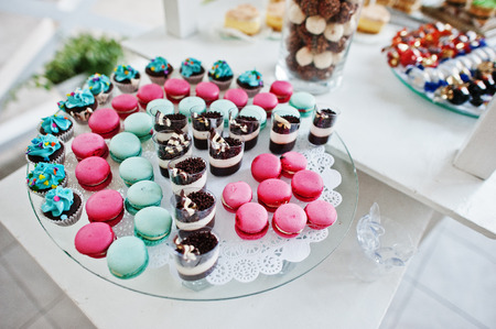Table catering with different cakes and macaron (French Macaroon) at wedding reception.の写真素材