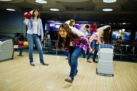 Group of girls having fun and play bowling at hen party.の写真素材