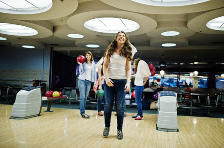 Group of girls having fun and play bowling at hen party.の写真素材